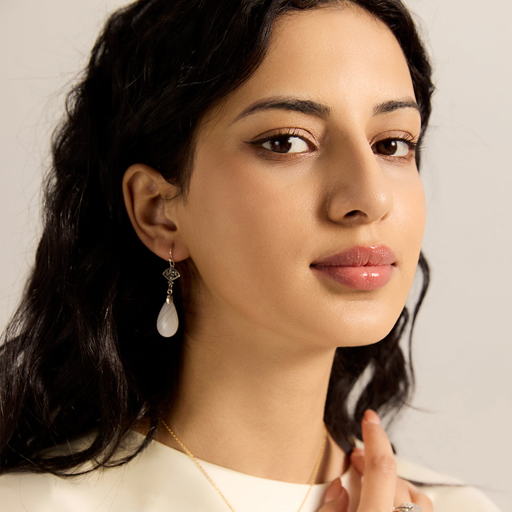 Model wearing Aveera designer silver plated filigree fan and white jade drop earring, showcasing elegant everyday style.
