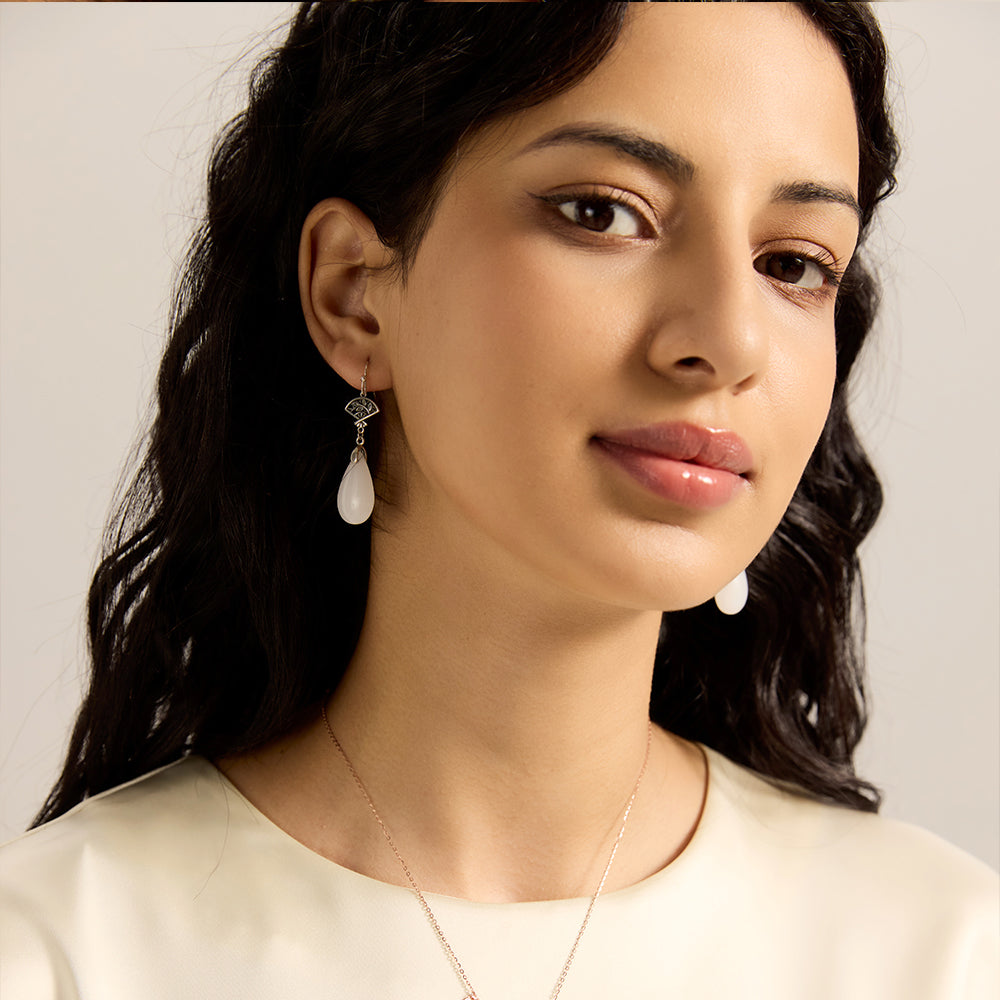 Model wearing Aveera designer silver plated filigree fan white jade drop earrings and matching necklace, elegant full look.