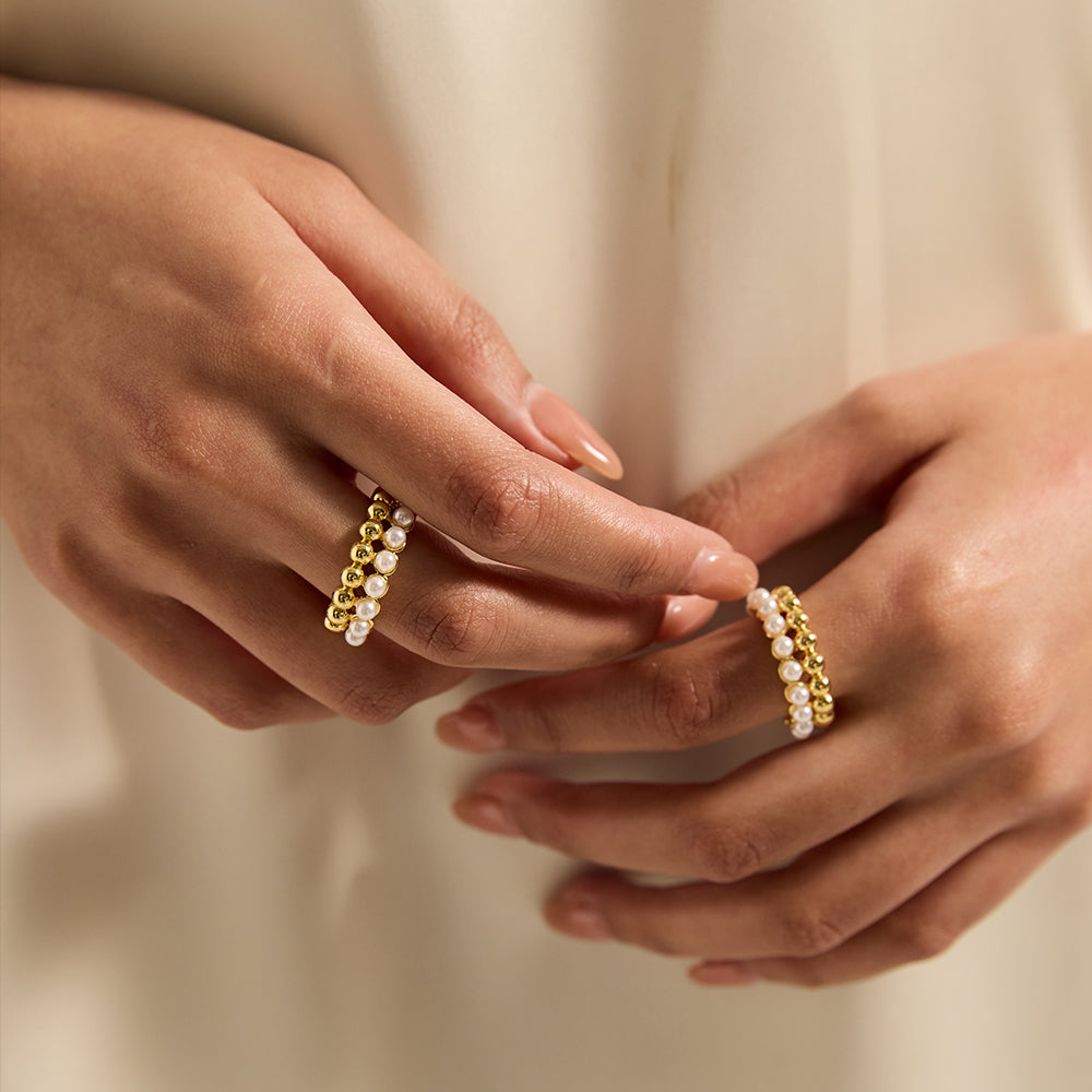 Model wearing Aveera designer gold tone crossover ring, showcasing its elegant fit and modern appeal.