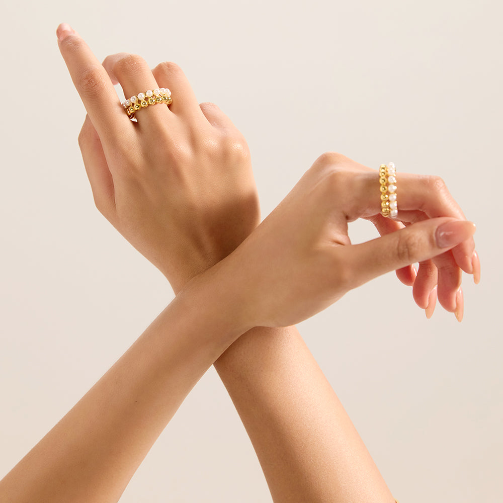 Detailed view of Aveera designer gold tone crossover ring, showcasing its craftsmanship and contemporary form.