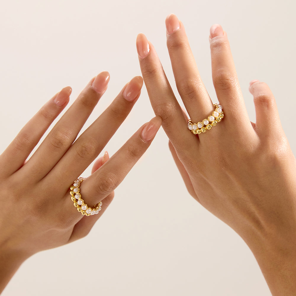 Aveera designer gold tone crossover ring styled with other accessories for a complete fashion look.