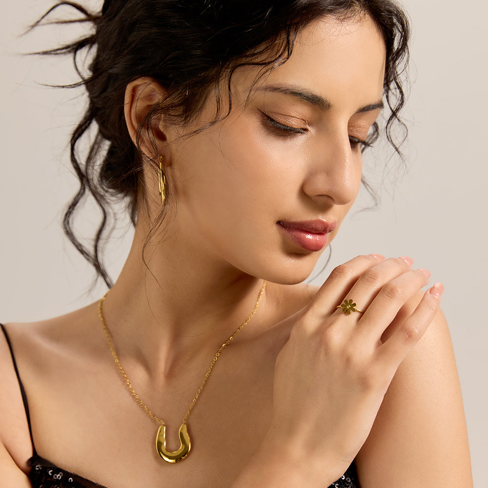 Model wearing Aveera designer gold tone small flower adjustable ring, highlighting its versatile and feminine appeal.