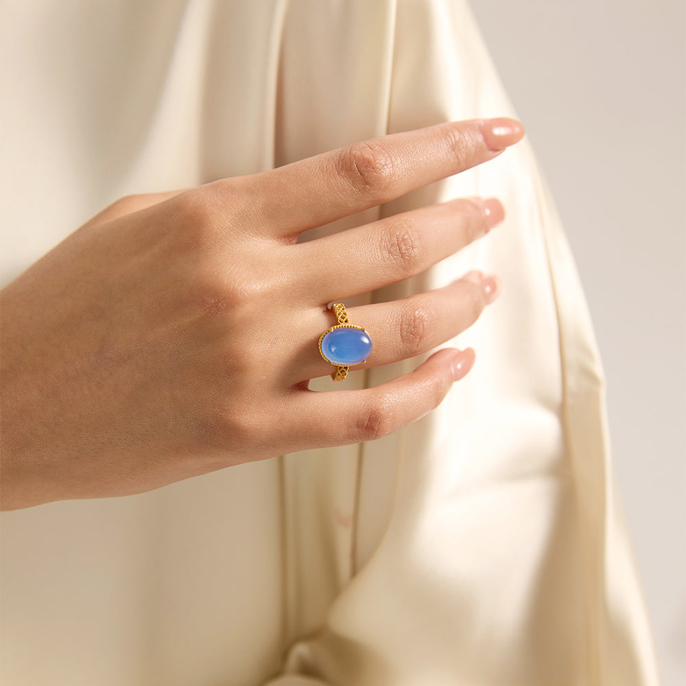 Close-up of Aveera designer gold tone triple circle blue stone ring, highlighting its delicate design and vibrant blue gem.