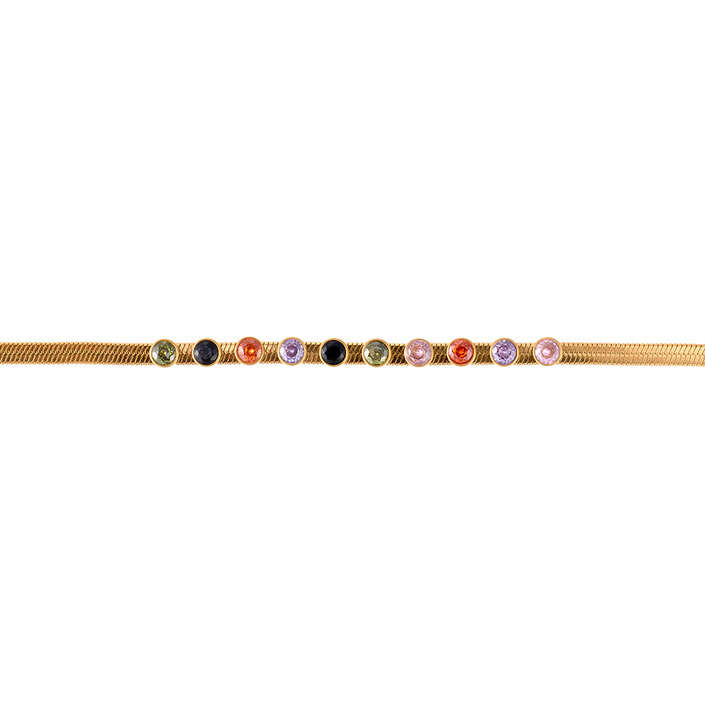 Model showcasing Aveera gold tone multi-color gemstone snake chain bracelet as a fashion statement, highlighting its luxurious appeal.