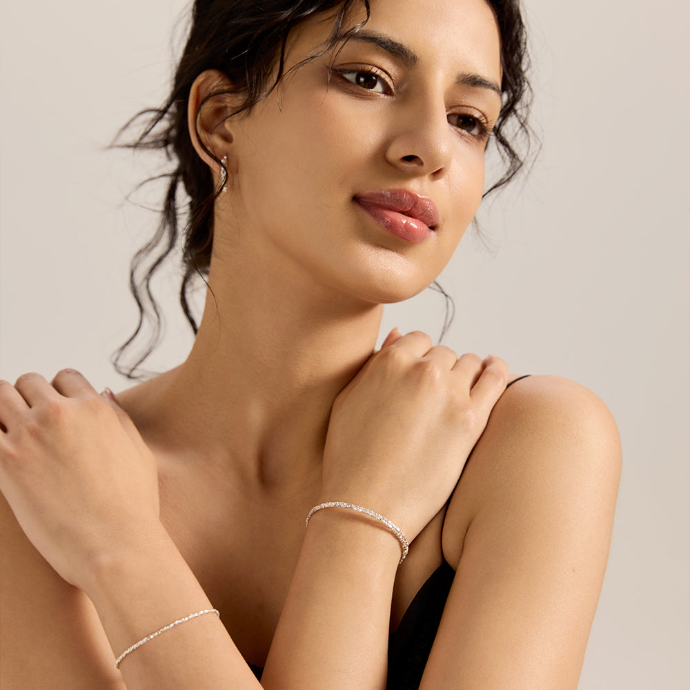 Model showcasing Aveera silver tone pave chain adjustable bracelet with upper body outfit, highlighting its overall elegant appeal.