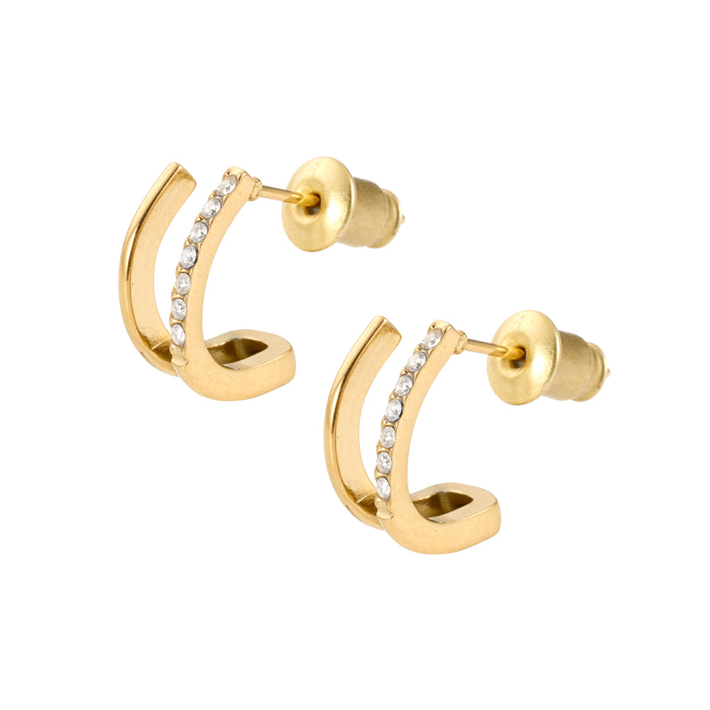 Pair of gold tone C-shaped stud earrings with micro pave CZ stones on white background.