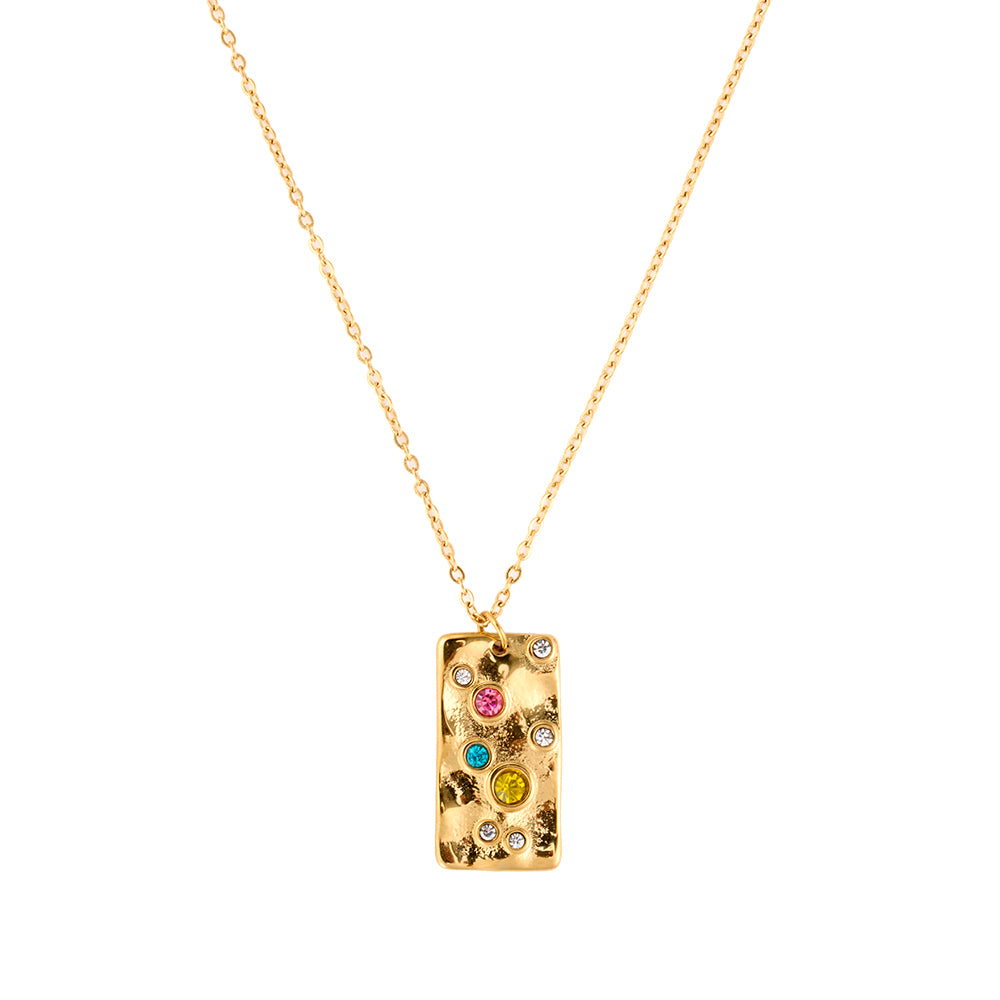 Gold tone hammered rectangular energy necklace with vibrant multi-color crystals, symbolizing protection and chakra balance, flat lay.