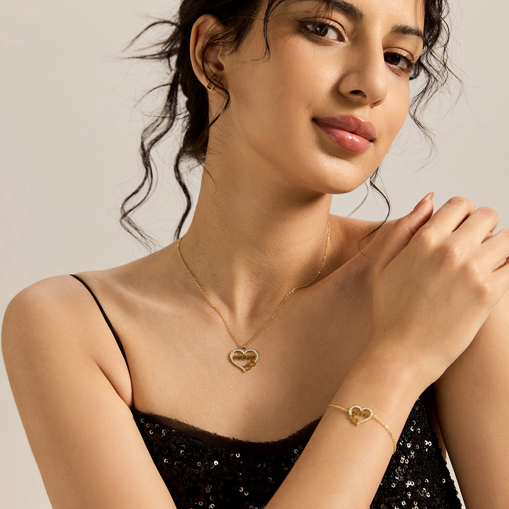 Woman wearing gold tone "MAMMA" heart bracelet and matching necklace.