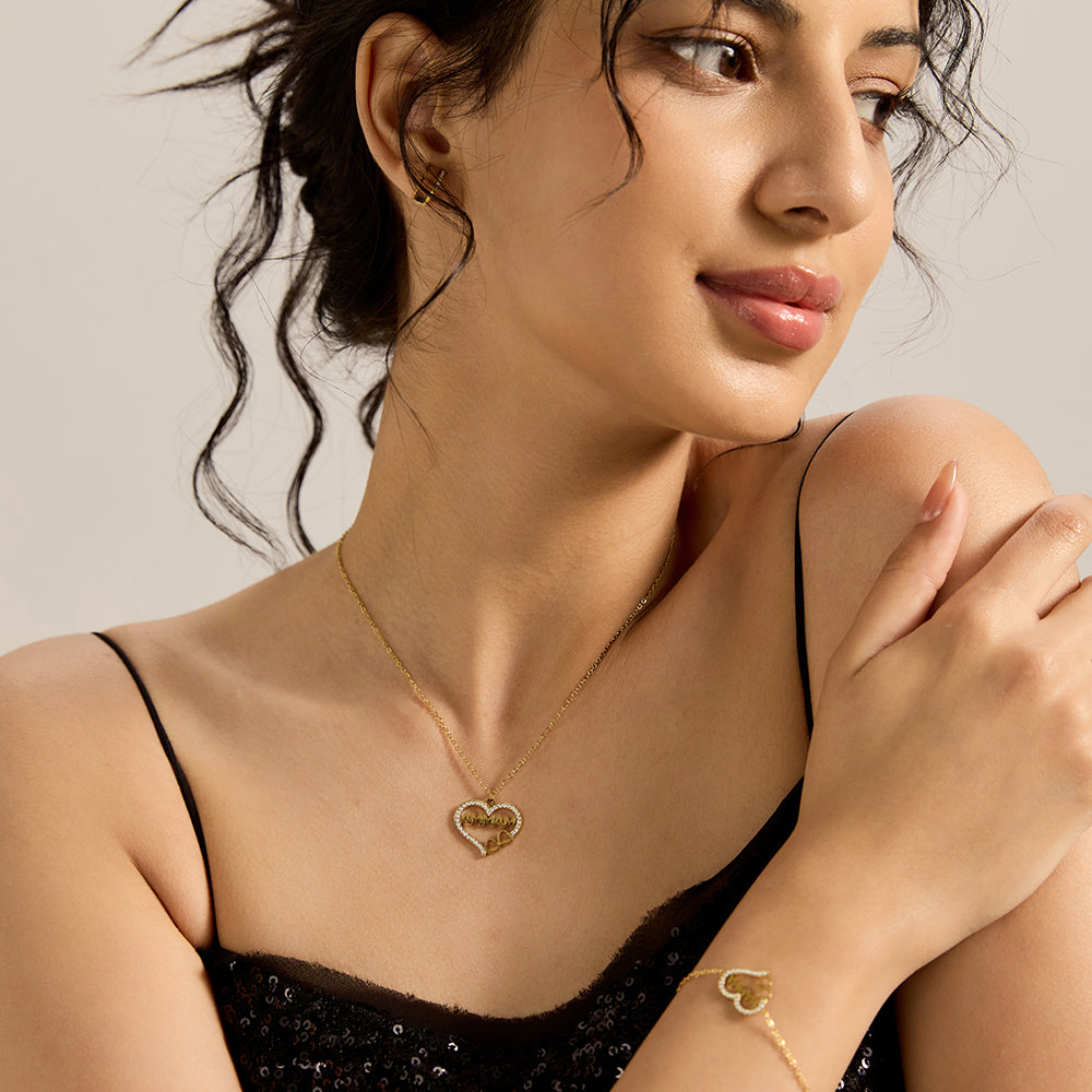 Woman wearing gold tone "MAMMA" heart necklace and matching bracelet.