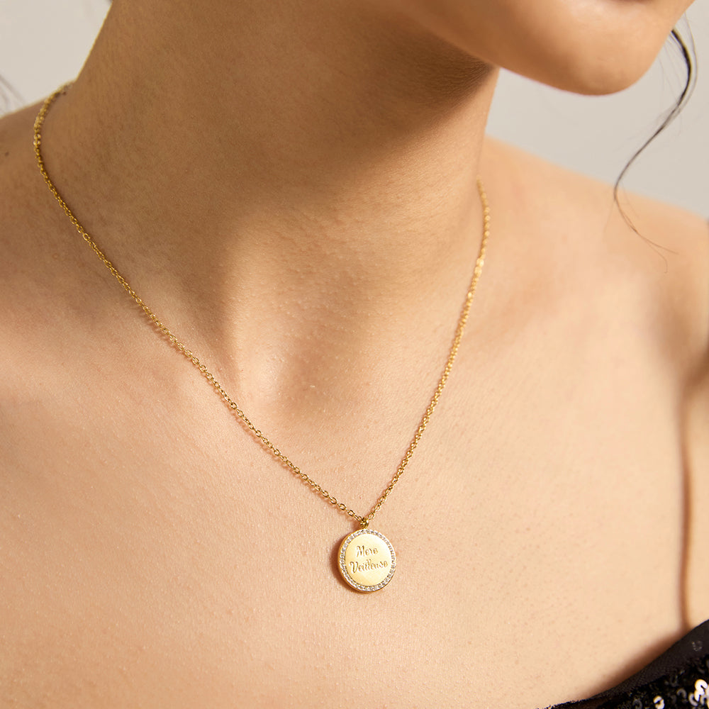 Woman wearing elegant gold tone "MERE MEILLEURE" coin pendant necklace.
