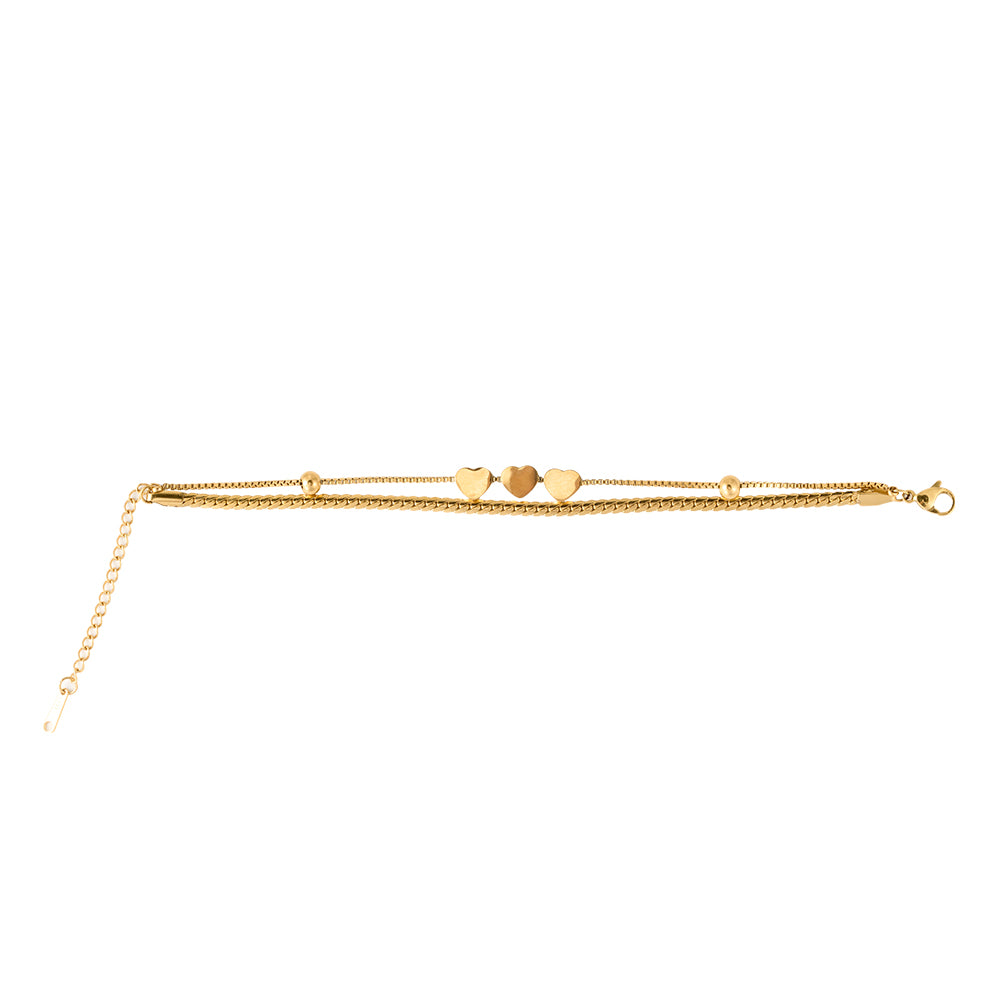 Chic gold tone multi-strand bracelet with three heart charms and textured chain.