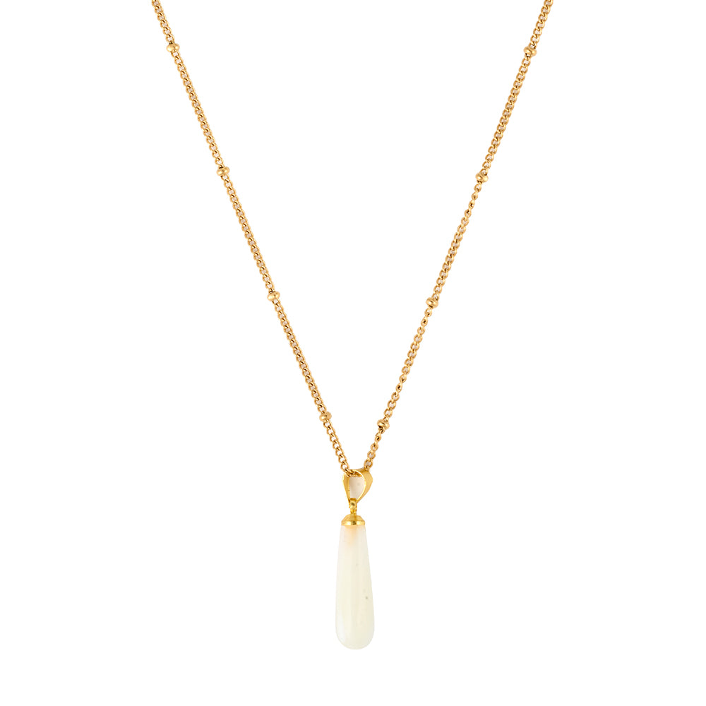 Elegant gold tone necklace with a large, unique irregular baroque pearl pendant, flat lay.