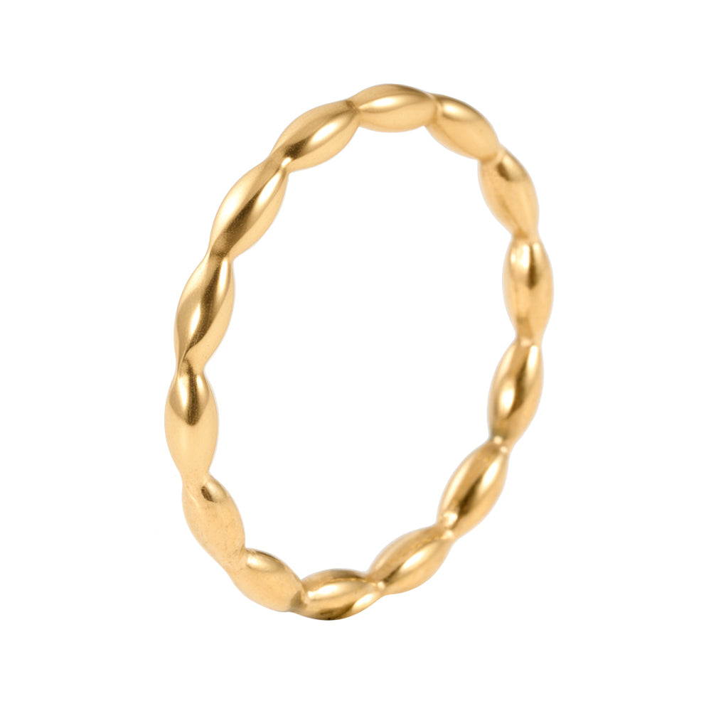 Gold tone dainty ring with an intricate textured twist band design on white background.