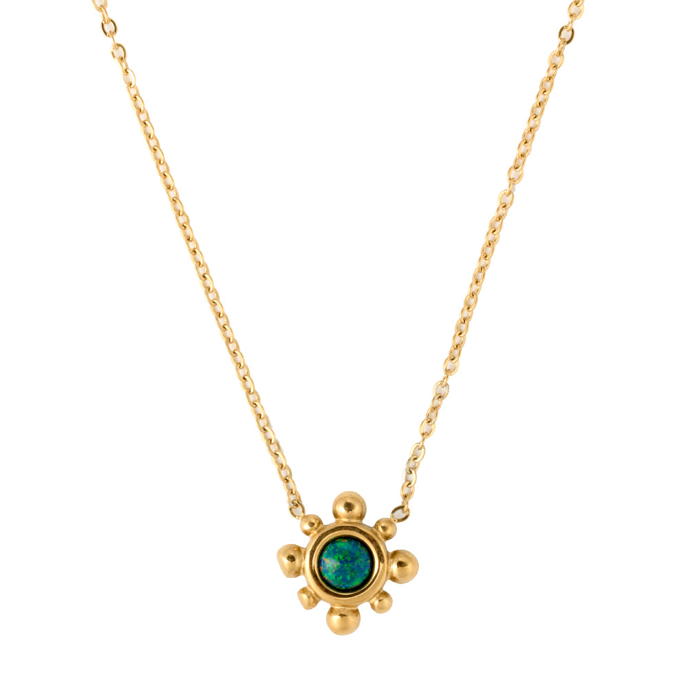 Elegant gold tone necklace with a central green stone pendant surrounded by small gold beads.