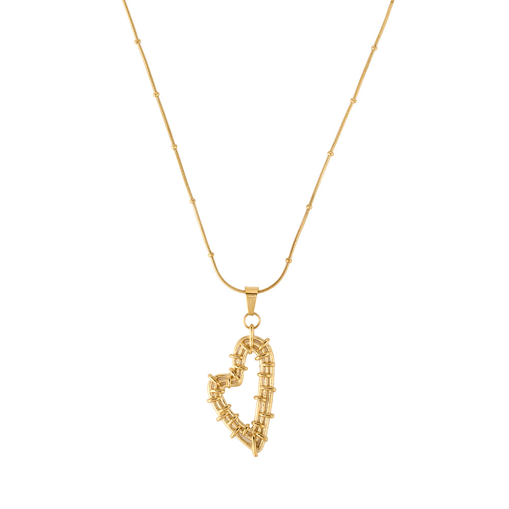 Artisan gold tone wire-wrapped heart pendant necklace on white background, unique love jewelry.