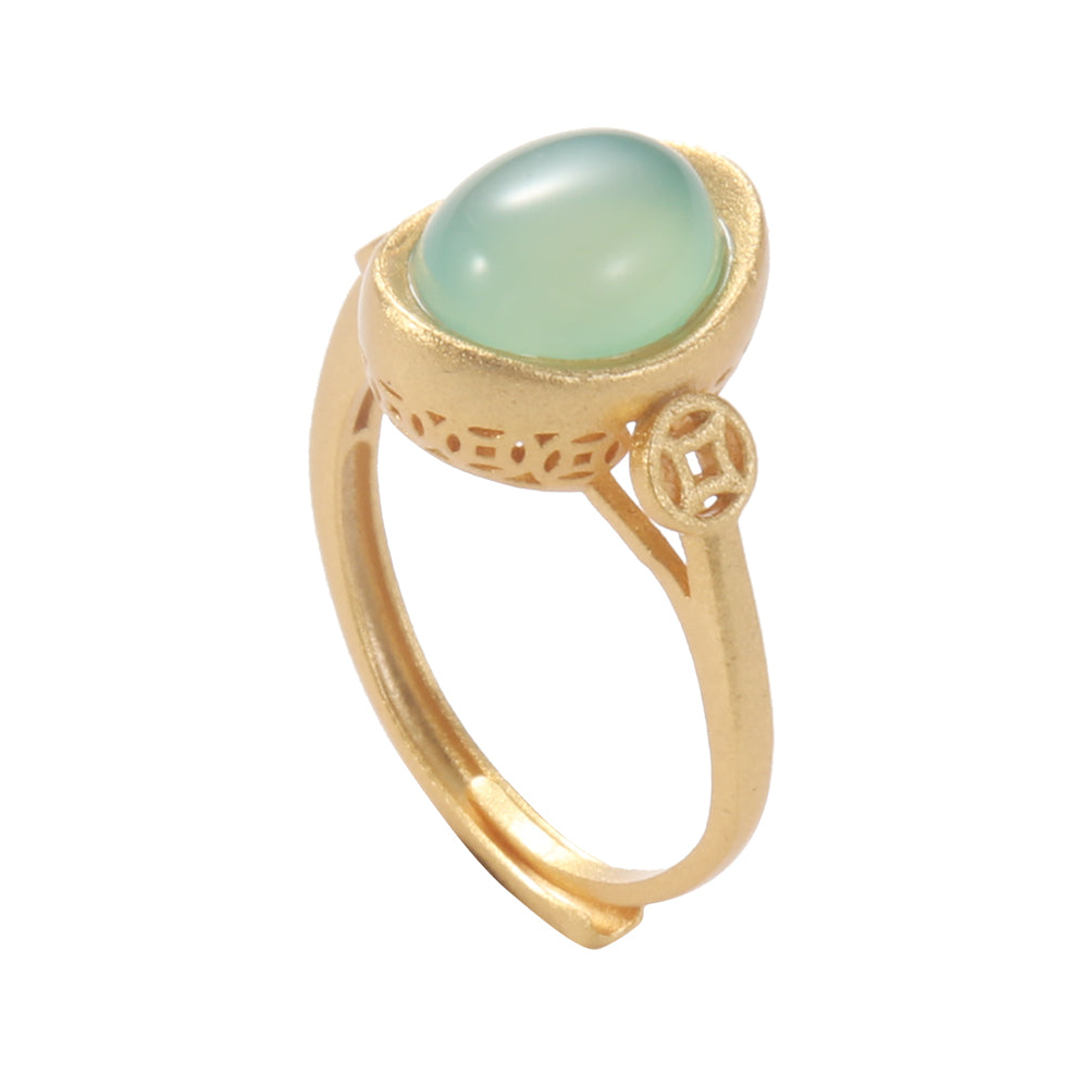 Close-up of the gold tone Yuan Bao ingot ring, showcasing the intricate details of the ingot shape, the smooth green gemstone, and the coin.