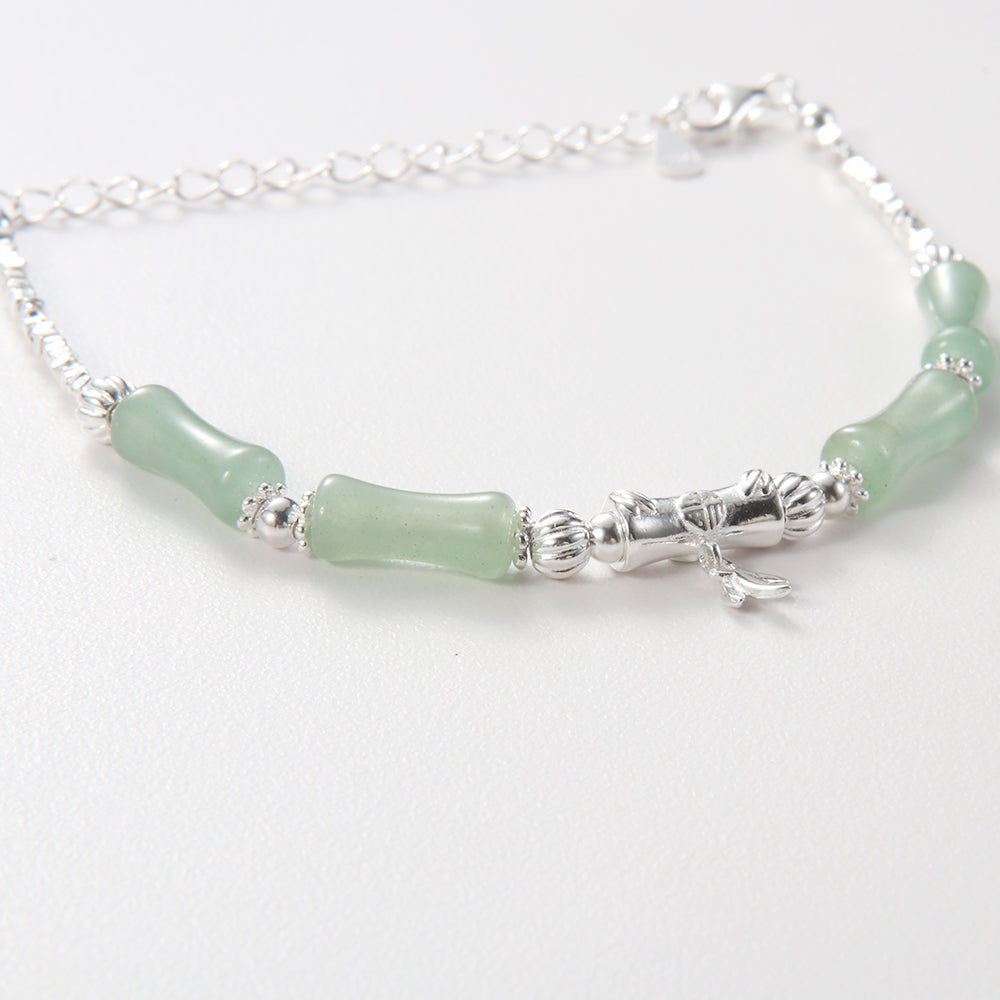 Serene green jade bamboo bracelet with silver tone leaf charm.