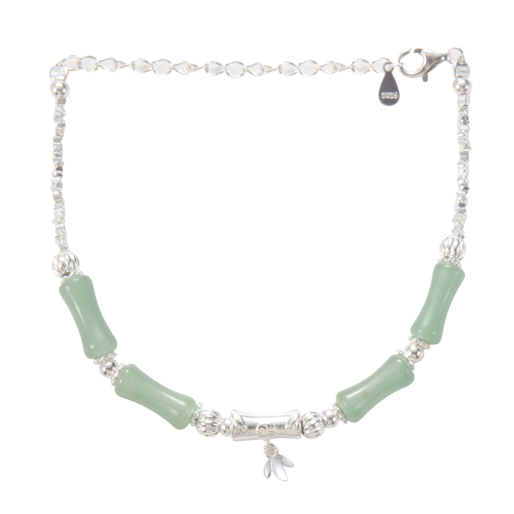 Woman wearing green jade bamboo bracelet, showcasing fit and style.