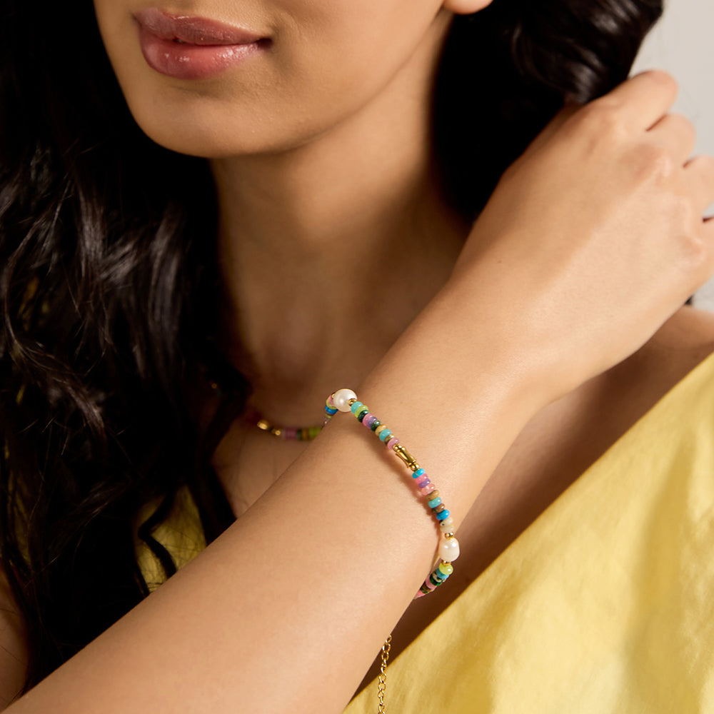 Vibrant multi-color beaded bracelet with delicate pearl and gold tone accents.