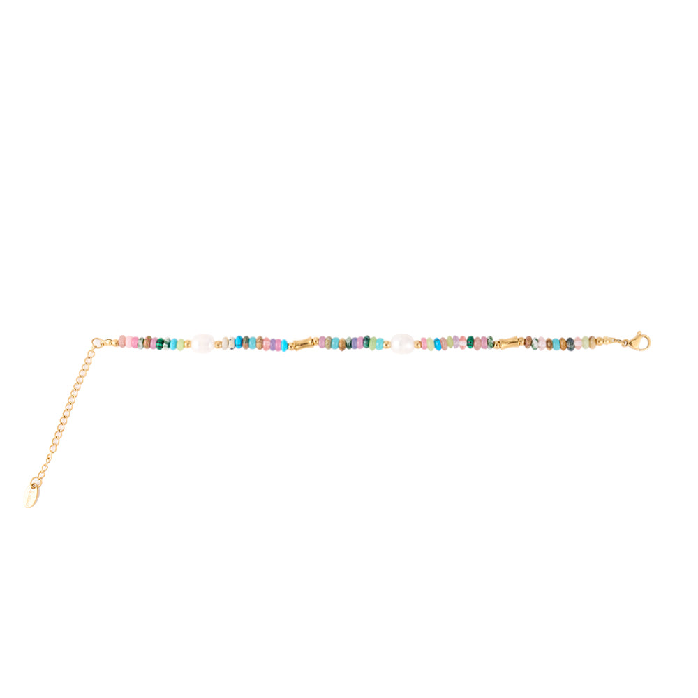 Close-up of multi-color beaded bracelet with pearl accents on woman's wrist.
