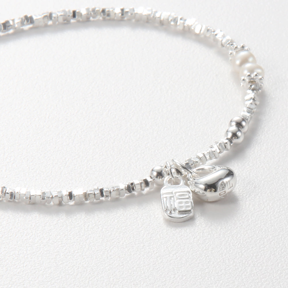 A close-up detail of the silver beaded bracelet clearly shows the "Fu" pendant, the gourd-shaped pendant, and two round pearls.