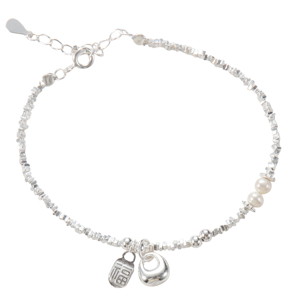 A close-up of the silver beaded bracelet highlights the delicate detail of the pearl and silver beads, and the "Fu" pendant.