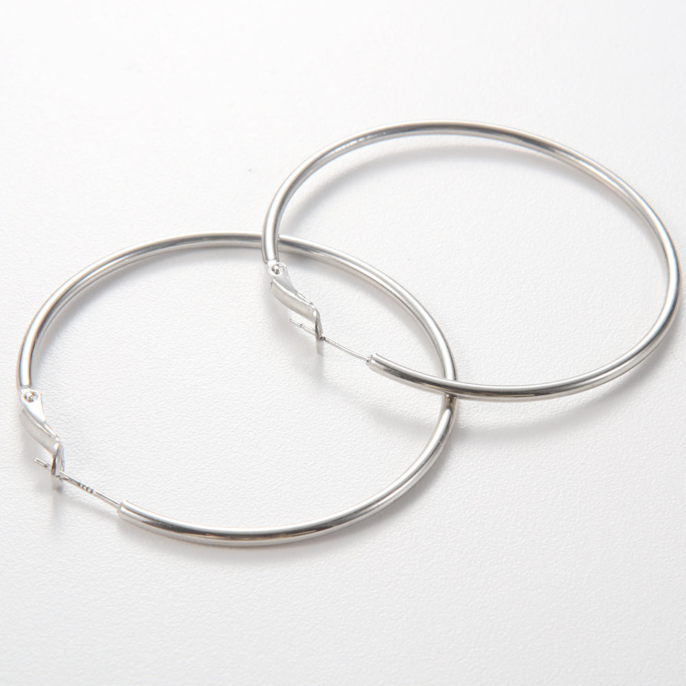 Pair of silver tone large, thin classic hoop earrings on white background.