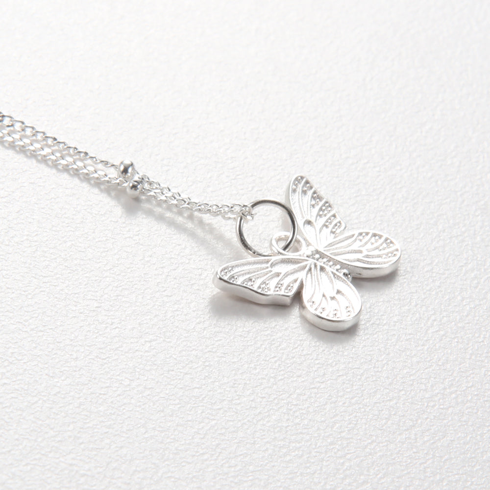 Elegant sterling silver butterfly pendant necklace on a white background, showcasing the full design.